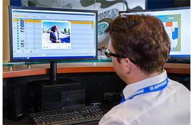A security guard is monitoring building on screen