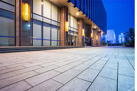 Sidewalk along with a office building at night